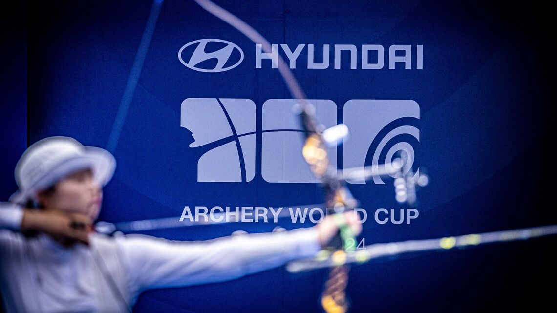 A blurred-out archer in front of the Hyundai World Cup logo